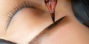 Permanent Makeup Brow Service being depicted. Using a PMU tattoo tool on client brow, creating defined brow. Services available at Fabulously Beautiful, Sutton Valence, Kent